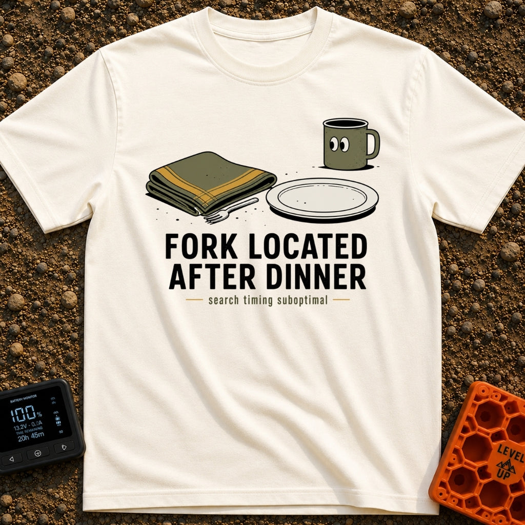 Fork Found Too Late - T-Shirt in Ivory - A cartoon illustration showing a fork partially hidden under a folded green...