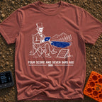 Lincoln Unplugged Adventure - T-Shirt in Brick - A line drawing of Abraham Lincoln sitting in a folding camp chair by a...