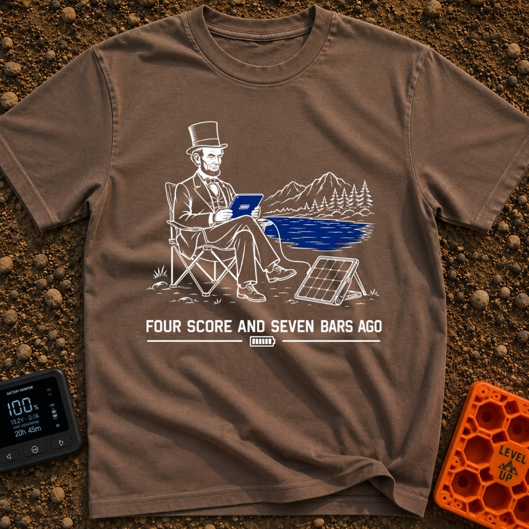 Lincoln Unplugged Adventure - T-Shirt in Espresso - A line drawing of Abraham Lincoln sitting in a folding camp chair by...