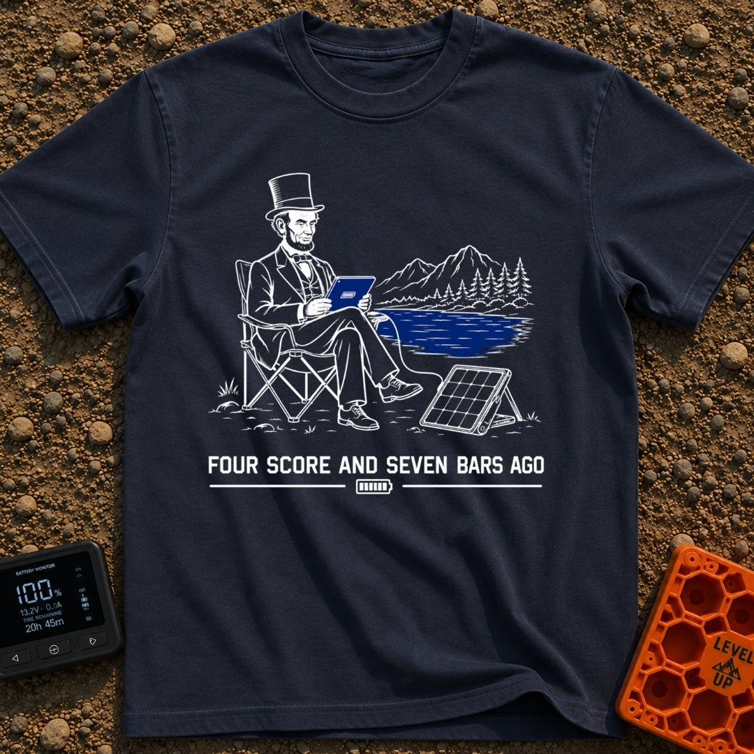 Lincoln Unplugged Adventure - T-Shirt in Navy - A line drawing of Abraham Lincoln sitting in a folding camp chair by a...