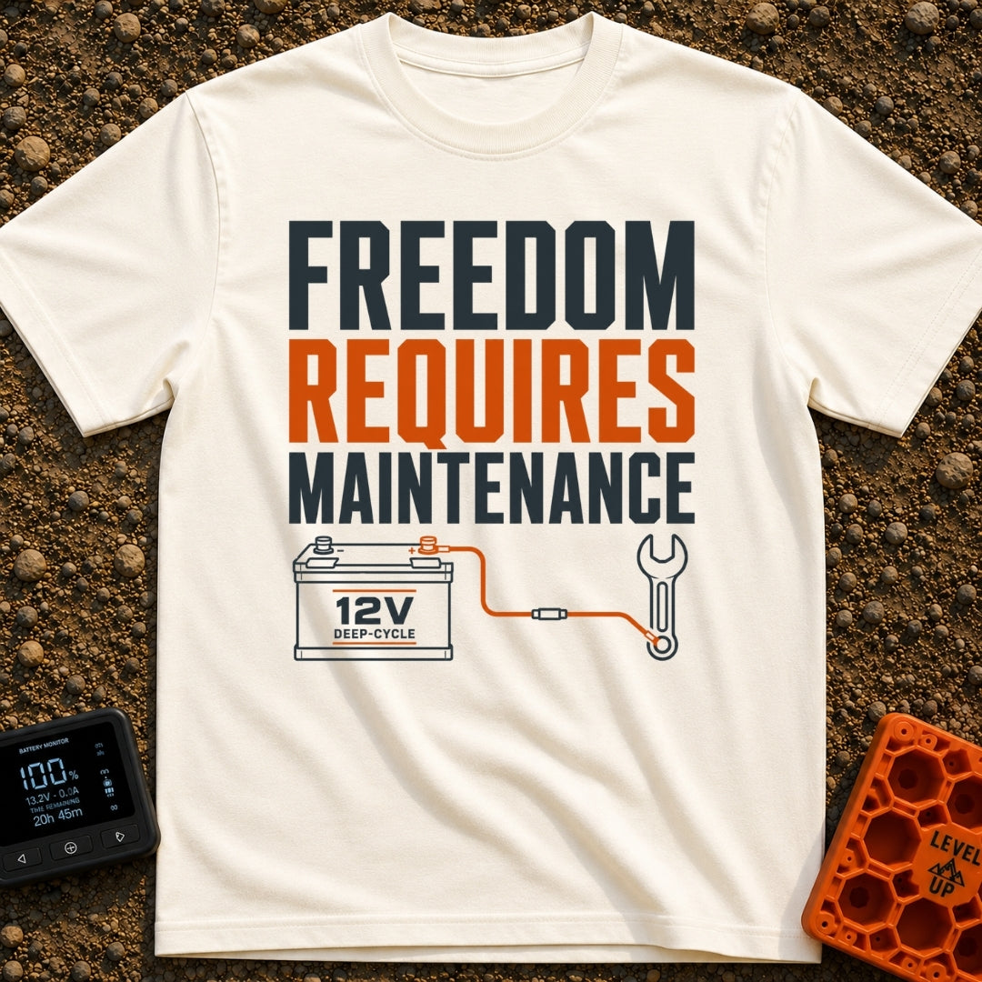Freedom Under Maintenance - T-Shirt in Ivory - A graphic design with the text "FREEDOM REQUIRES MAINTENANCE" stacked in...