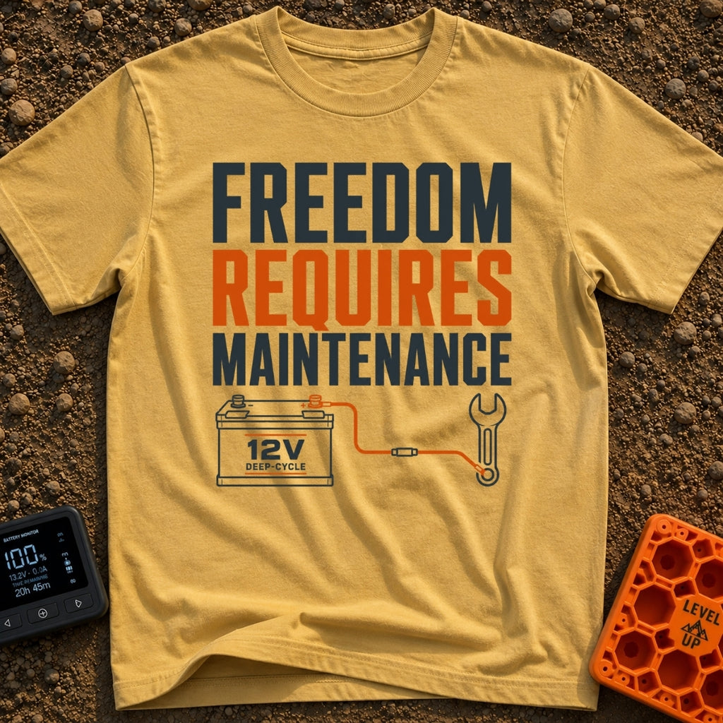 Freedom Under Maintenance - T-Shirt in Mustard - A graphic design with the text "FREEDOM REQUIRES MAINTENANCE" stacked in...
