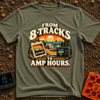8 Tracks To Amps - T-Shirt in Moss - A retro-style illustration showing an 8-track tape and a digital battery monitor...