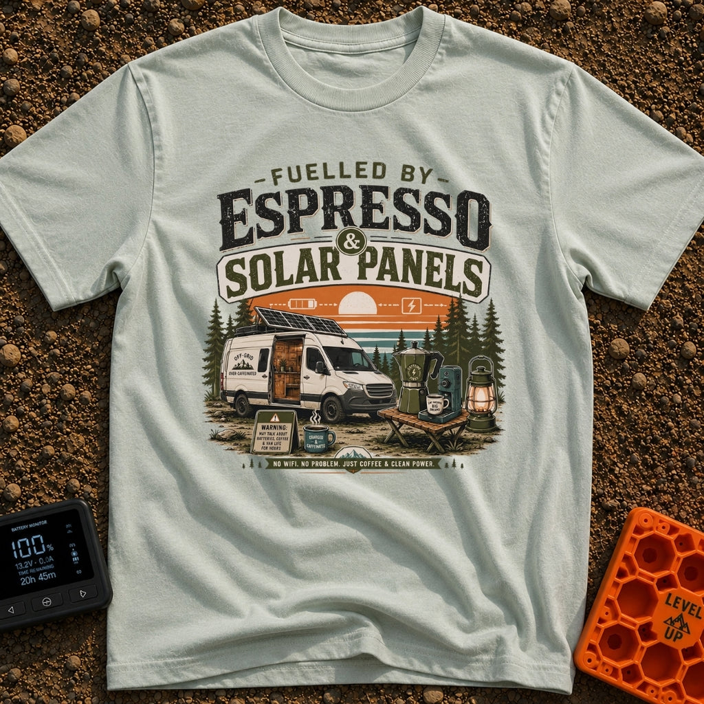 Espresso and Solar - T-Shirt in Bay - A white camper van with a large solar panel angled on its roof is parked in a pine...