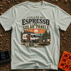 Espresso and Solar - T-Shirt in Bay - A white camper van with a large solar panel angled on its roof is parked in a pine...