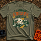 Grandpas Great Escape - T-Shirt in Moss - A vintage-style Class C motorhome drives away down a winding paved road toward...