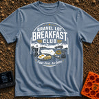 Gravel Gourmet Gathering - T-Shirt in Blue Jean - A camping breakfast setup featuring a Moka pot, a pan of eggs and...
