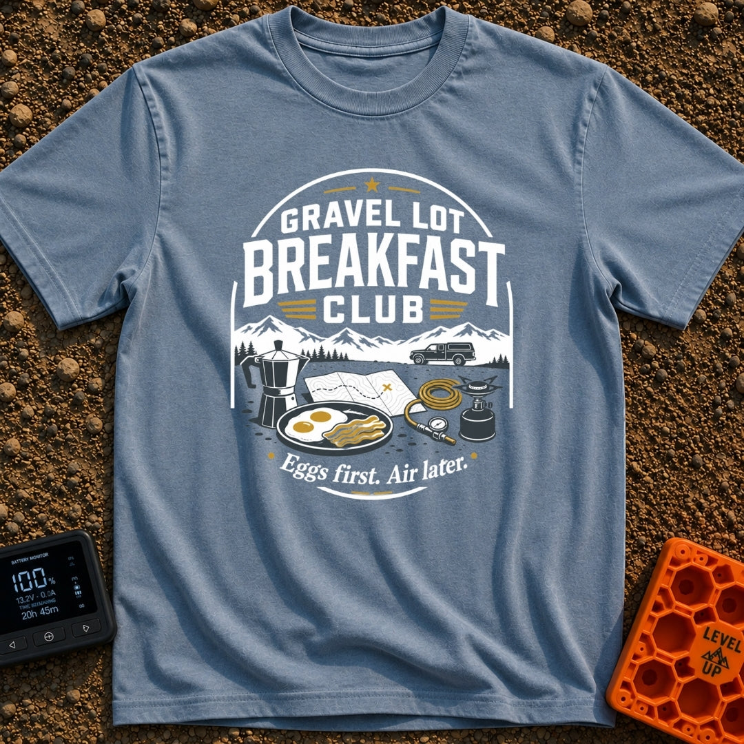 Gravel Gourmet Gathering - T-Shirt in Blue Jean - A camping breakfast setup featuring a Moka pot, a pan of eggs and...