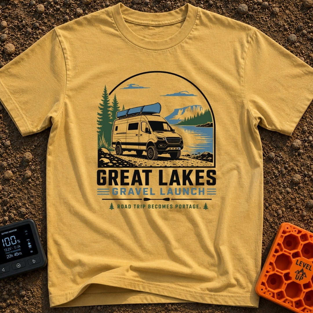Canoe Venture Vibes - T-Shirt in Mustard - A white camper van with a blue canoe strapped to its roof is parked on a...