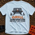 Heated Grill Negotiations - T-Shirt in Chambray - An illustration of a grey portable camping grill with a temperature...