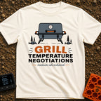 Heated Grill Negotiations - T-Shirt in Ivory - An illustration of a grey portable camping grill with a temperature gauge,...