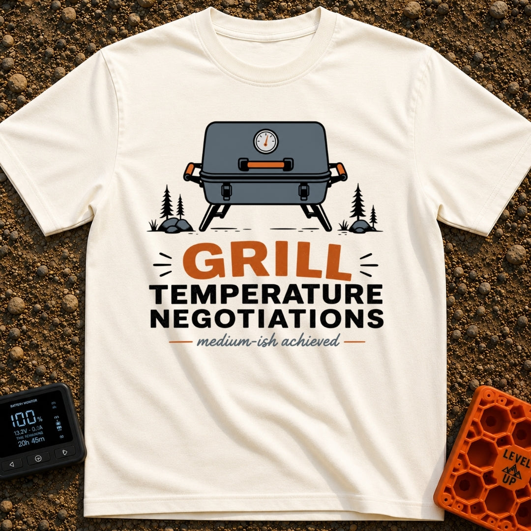 Heated Grill Negotiations - T-Shirt in Ivory - An illustration of a grey portable camping grill with a temperature gauge,...