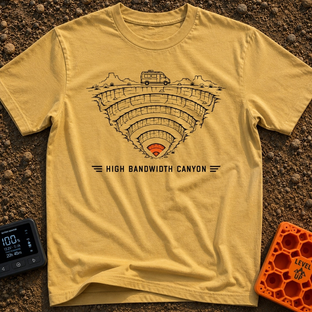 Canyon Wide Web - T-Shirt in Mustard - A black-and-white line drawing of a camper van parked on the rim of a deep,...