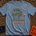 High Clearance Low Drama - T-Shirt in Blue Jean - A lifted camper van is shown driving over rocks next to two orange...