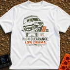 High Clearance Low Drama - T-Shirt in White - A lifted camper van is shown driving over rocks next to two orange vehicle...