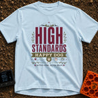 High Standards Happy Dog - T-Shirt in Chambray - A typographic design featuring the text "HIGH STANDARDS HAPPY DOG" and...