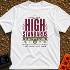High Standards Happy Dog - T-Shirt in White - A typographic design featuring the text "HIGH STANDARDS HAPPY DOG" and...
