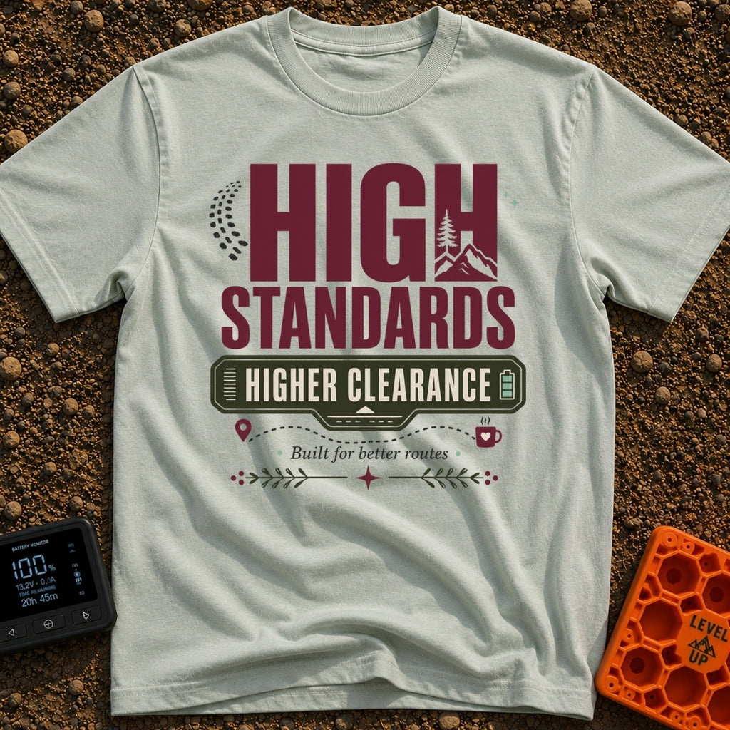 Elevated Adventure Standards - T-Shirt in Bay - A typographic design featuring the text "HIGH STANDARDS HIGHER CLEARANCE"...