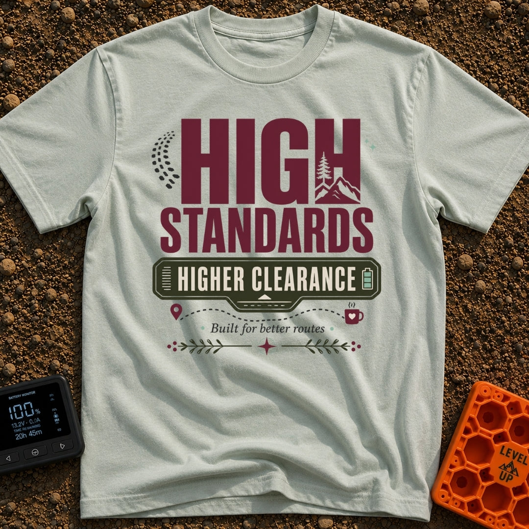 Elevated Adventure Standards - T-Shirt in Bay - A typographic design featuring the text "HIGH STANDARDS HIGHER CLEARANCE"...
