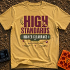 Elevated Adventure Standards - T-Shirt in Mustard - A typographic design featuring the text "HIGH STANDARDS HIGHER...