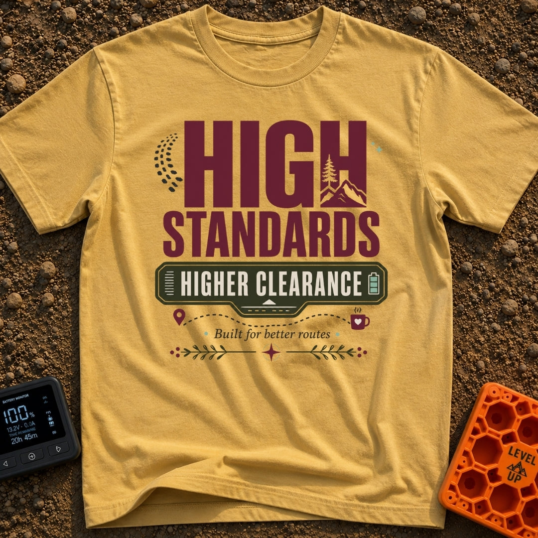 Elevated Adventure Standards - T-Shirt in Mustard - A typographic design featuring the text "HIGH STANDARDS HIGHER...