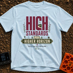High Standards Higher Horizon - T-Shirt in Chambray - The artwork features the text "HIGH STANDARDS" with a mountain and...