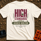 High Standards Higher Horizon - T-Shirt in Ivory - The artwork features the text "HIGH STANDARDS" with a mountain and...