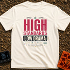 High Standards Low Drama - T-Shirt in Ivory - Typographic design reading "HIGH STANDARDS LOW DRAMA" and "FULL CHARGE,...
