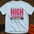 Standards And Signals - T-Shirt in Chambray - A typographic design reading "HIGH STANDARDS LOW SIGNAL" and "Still...