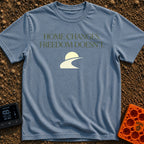 Home Moves Freedom Stays - T-Shirt in Blue Jean - Text reading "HOME CHANGES. FREEDOM DOESN'T." in olive green serif font...