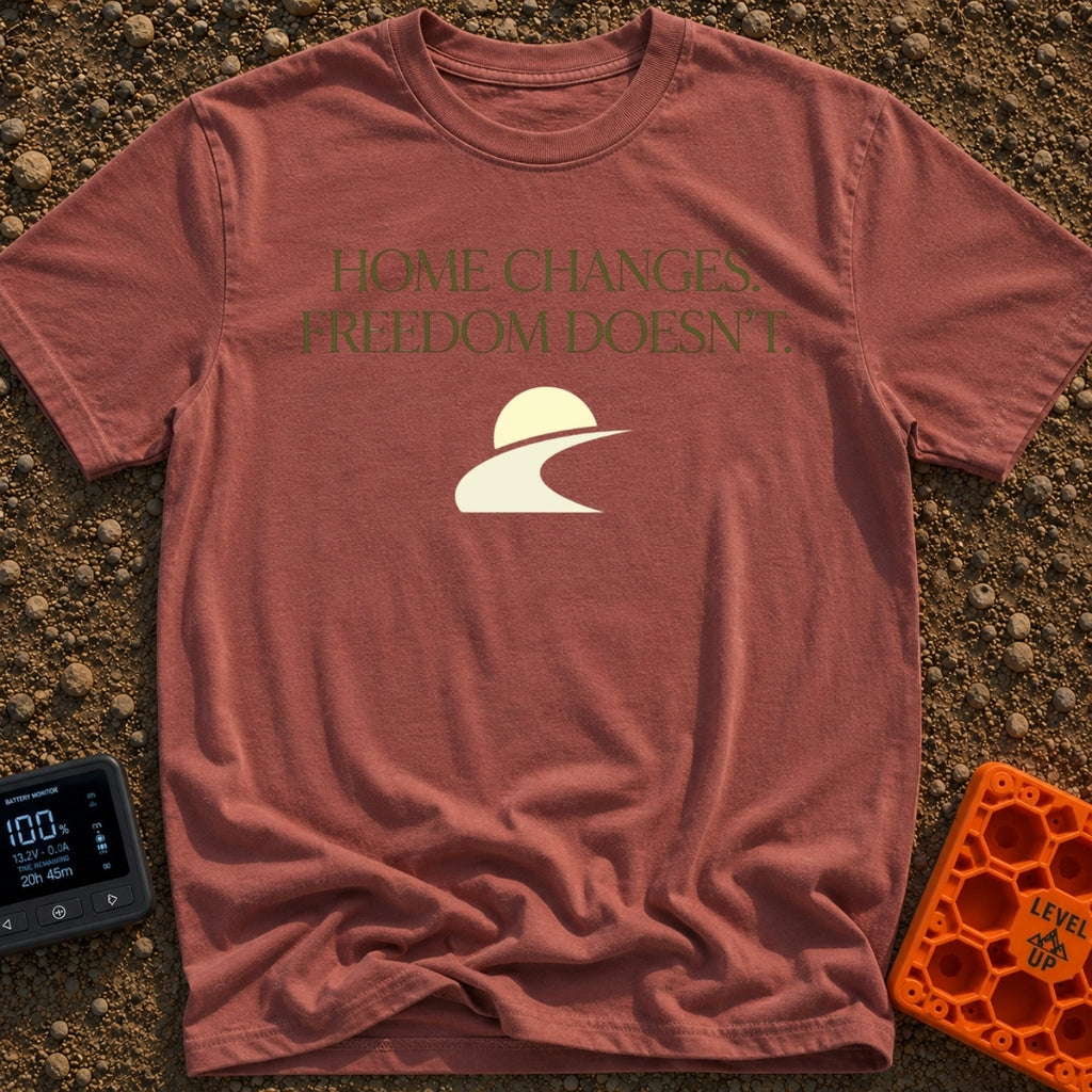 Home Moves Freedom Stays - T-Shirt in Brick - Text reading "HOME CHANGES. FREEDOM DOESN'T." in olive green serif font...