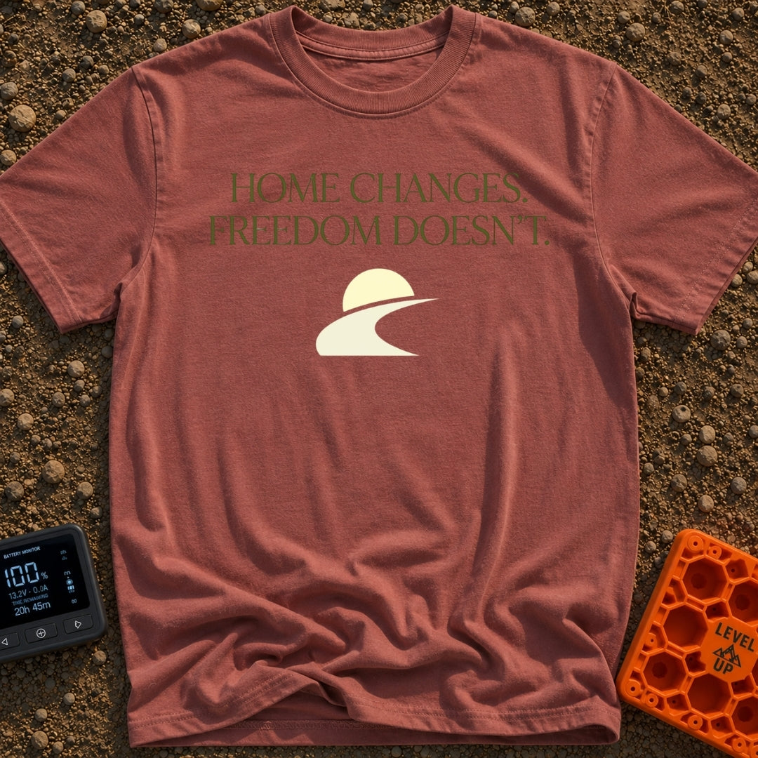 Home Moves Freedom Stays - T-Shirt in Brick - Text reading "HOME CHANGES. FREEDOM DOESN'T." in olive green serif font...