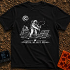 Houston We Have Bars - T-Shirt in Black - A black and white line-art illustration of an astronaut on the moon holding up...