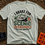 I Brake For Overlooks - T-Shirt in Bay - A Class C motorhome drives along a winding paved road next to a brown 'Scenic...