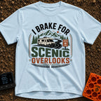 I Brake For Overlooks - T-Shirt in Chambray - A Class C motorhome drives along a winding paved road next to a brown...