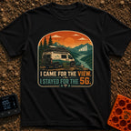 Views and 5G - T-Shirt in Black - A white and teal camper van parked by a river with mountains at sunset, featuring a...