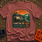 Views and 5G - T-Shirt in Brick - A white and teal camper van parked by a river with mountains at sunset, featuring a...