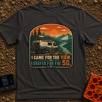 Views and 5G - T-Shirt in Graphite - A white and teal camper van parked by a river with mountains at sunset, featuring a...