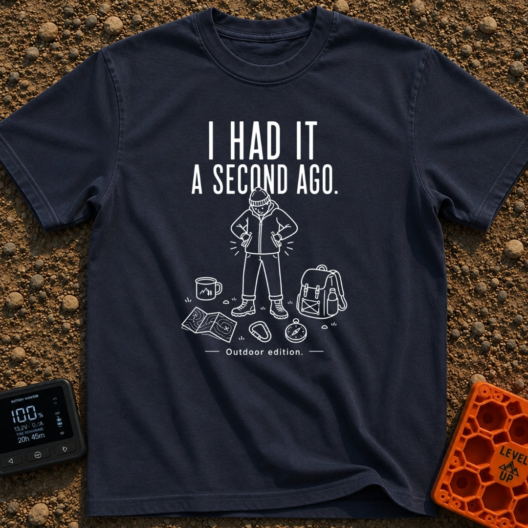 It Was Just Here - T-Shirt in Navy - A white line drawing of a person in a beanie and jacket looking down and searching...