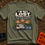 I Am Running Scenarios - T-Shirt in Moss - A white camper van drives toward three directional signs reading 'Coffee',...