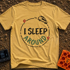 I Sleep Around - T-Shirt in Mustard - A white camper van driving along a circular dashed line with two map location pins,...