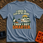 Retired From The Ground - T-Shirt in Blue Jean - A graphic illustrating an evolution, showing a traditional A-frame tent...