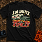 Sexy And I Tow - T-Shirt in Black - A retro-style illustration of a green pickup truck towing a large fifth-wheel camper...