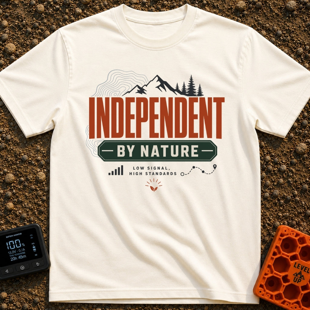 Independent By Nature - T-Shirt in Ivory - A graphic design featuring mountain peaks, pine trees, and topographical map...
