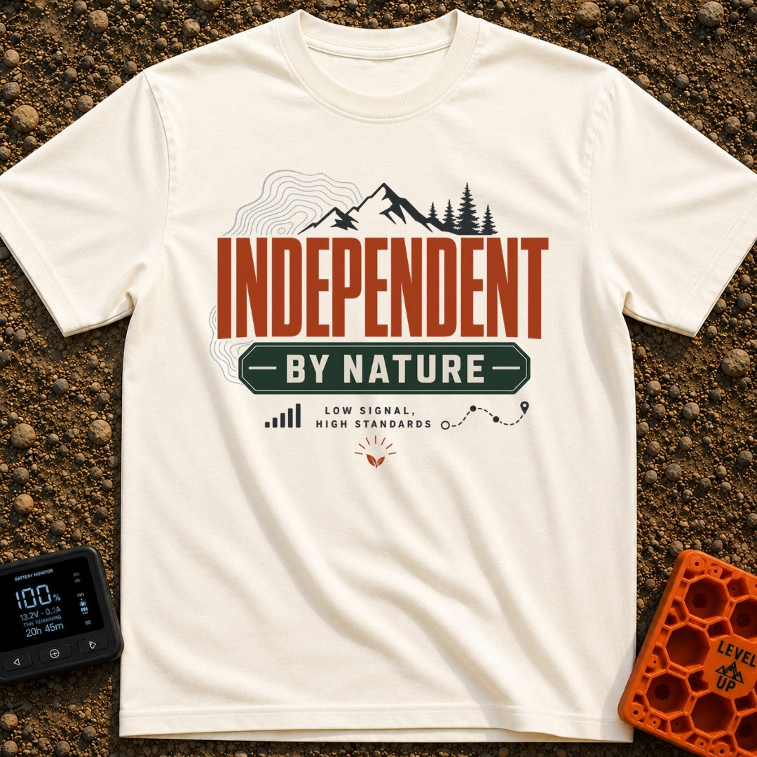 Independent By Nature - T-Shirt in Ivory - A graphic design featuring mountain peaks, pine trees, and topographical map...