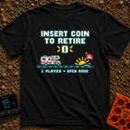 Insert Coin To Retire - T-Shirt in Black - A retro 8-bit pixel art design showing a Class C RV driving on a dashed road...