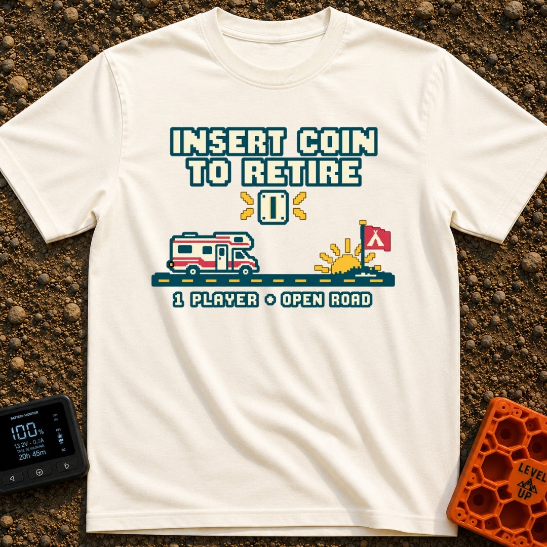 Insert Coin To Retire - T-Shirt in Ivory - A retro 8-bit pixel art design showing a Class C RV driving on a dashed road...