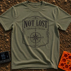 Elsewhere On Purpose - T-Shirt in Moss - A black and white distressed graphic featuring an ornate border, with bold text...