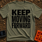 Put It In Drive - T-Shirt in Moss - Large, bold black text stacked in three lines reading "KEEP MOVING FORWARD" with no...