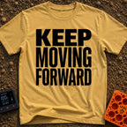 Put It In Drive - T-Shirt in Mustard - Large, bold black text stacked in three lines reading "KEEP MOVING FORWARD" with...